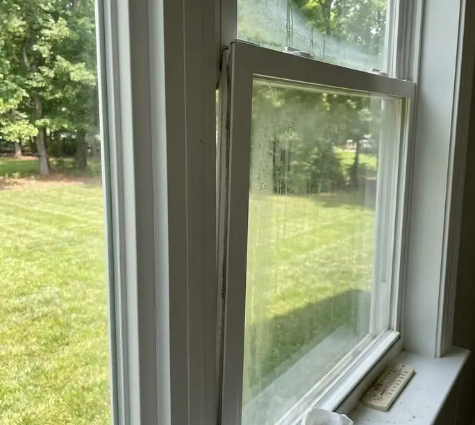 Aging window with failed seals letting in drafts before WowFix repair in Kannapolis