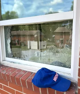 Broken window pane on a brick home before WowFix glass replacement