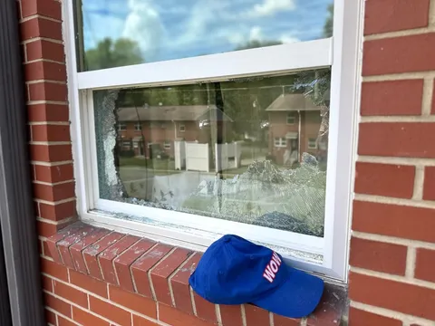 Broken window pane on a brick home before WowFix glass replacement — WowFix cap on the sill
