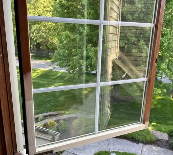 Serviced casement window swinging open smoothly after a WowFix repair