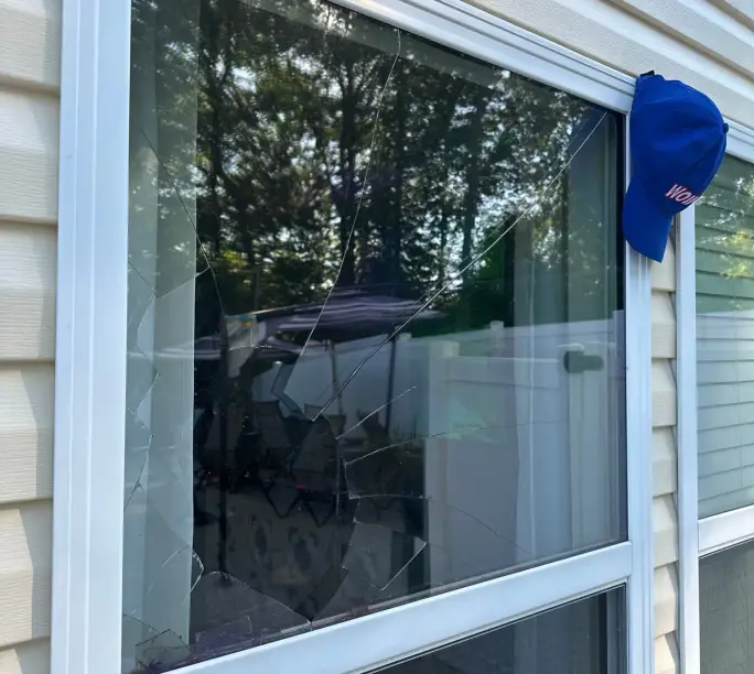 Shattered double-hung pane on a Charlotte-area home — WowFix cap on the frame, glass unit swaps on its own