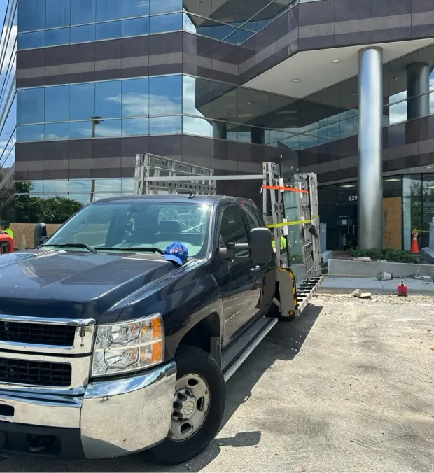 WowFix glass truck loaded at an office tower — replacement units delivered to the job