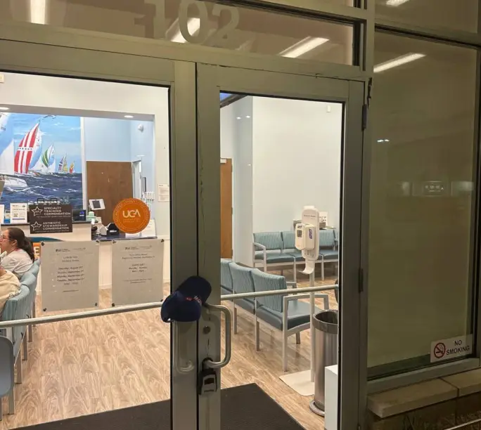 Medical office double glass doors serviced by WowFix — cap on the handle, patients still coming through