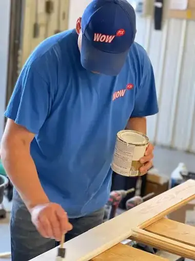 WowFix craftsman priming a rebuilt window wood section