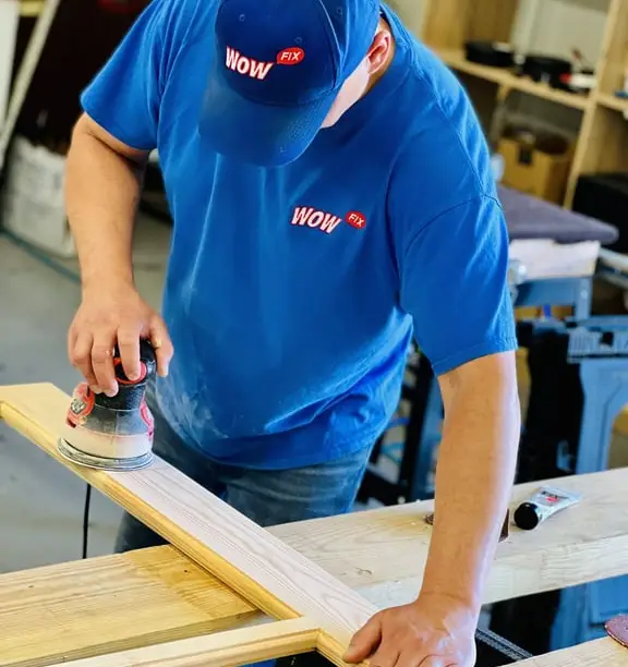 WowFix craftsman sanding a milled repair piece in the workshop