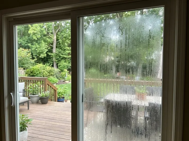 Patio sliding door glass panel replaced with a clear tempered unit