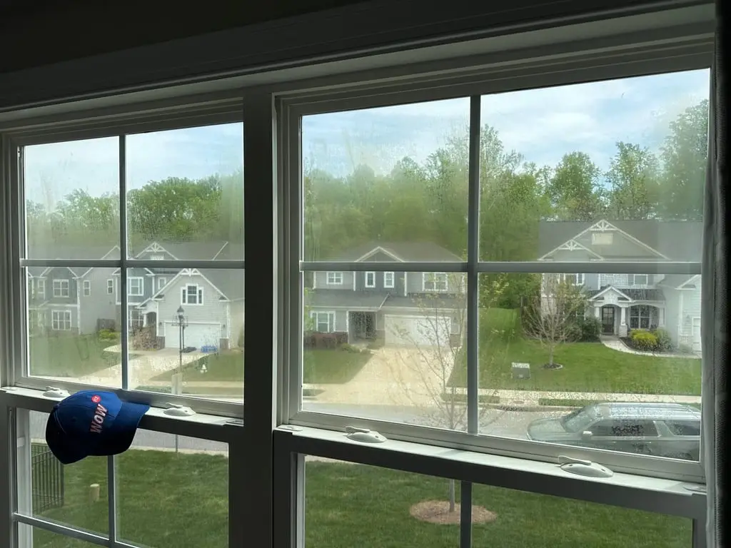Double-pane window clouded with moisture from a failed seal before WowFix repair