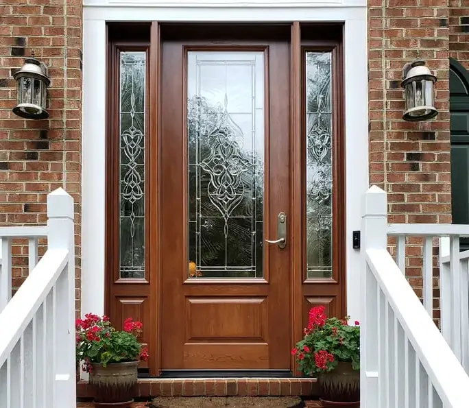 Entry door with decorative glass on a brick home — set clean and square