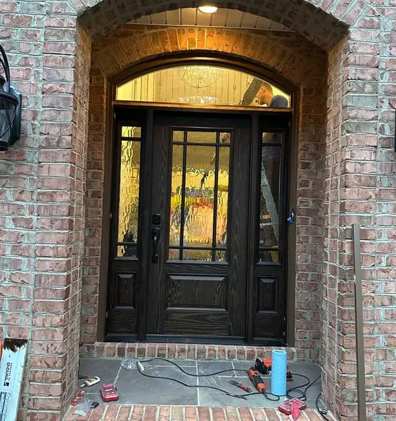 Entry door installation in progress — tools still on the step
