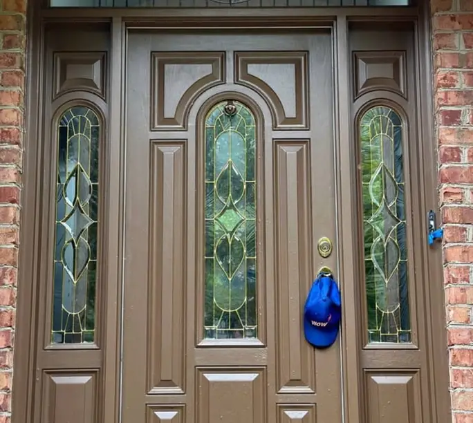 Entry door with decorative glass serviced by WowFix in Chapel Hill — cap on the handle
