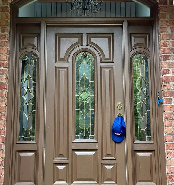 Restored entry door with sidelights — WowFix cap hung on the handle