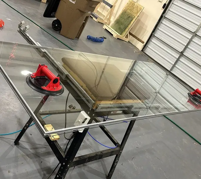 Made-to-measure insulated glass unit on the WowFix shop stand, suction cups still on the glass