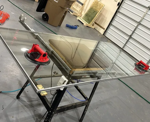 Replacement glass staged with suction cups on the WowFix bench for an Alpharetta job