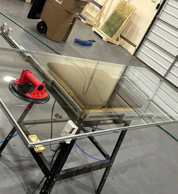 Made-to-measure insulated glass unit on the WowFix shop stand, suction cups still on the glass