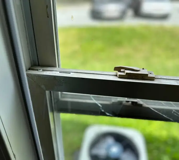 Builder-grade double-hung window with failed balancers held open during a WowFix diagnosis in Alpharetta