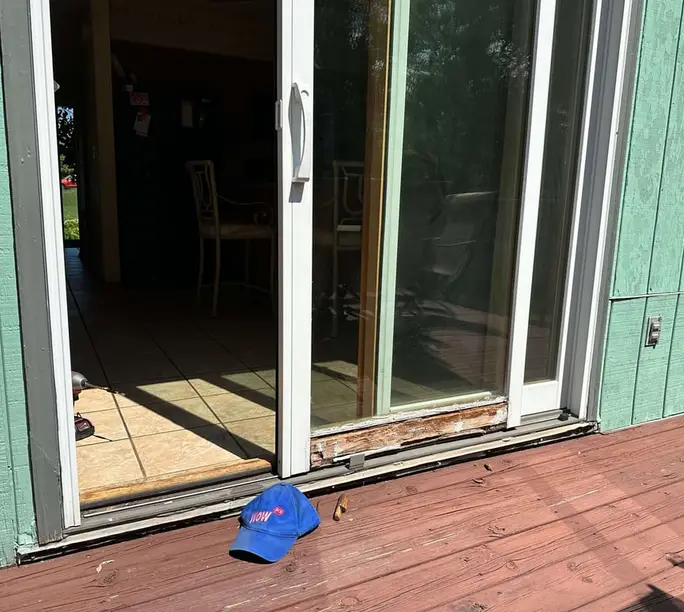 Patio door threshold rotted by years of water — WowFix cap marking it