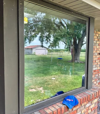 Large fixed picture window with crystal-clear new glass framing a backyard view after WowFix glass replacement near Charlotte, NC