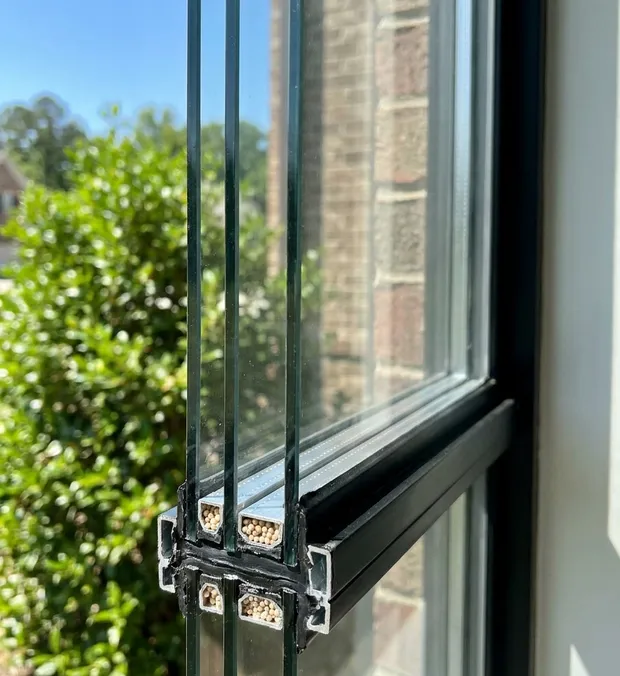 Cross-section of an insulated glass unit with rigid aluminum spacer and desiccant