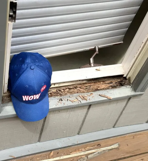 WowFix technician probing a shaded window sill for hidden rot at a Sandy Springs assessment