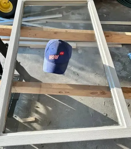 Freshly rebuilt and repainted white wood window sash on the workbench after WowFix rotted-wood restoration in Charlotte, NC