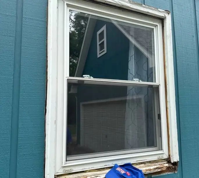 Genuinely rotted window sill on a brick home — the kind the catalog rebuilds in real wood from $375