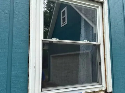 Double-hung window with a rotted-through sill before WowFix cut out the decay — WowFix cap on the sill