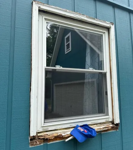 Double-hung window with a rotted-through sill before WowFix cut out the decay and rebuilt it with laminated wood — WowFix cap on the sill