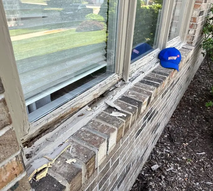 Rotted window sill on a brick Burlington home assessed for repair instead of replacement