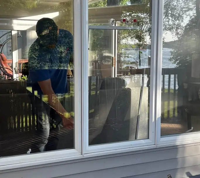 WowFix technician setting a window at a lakeside home
