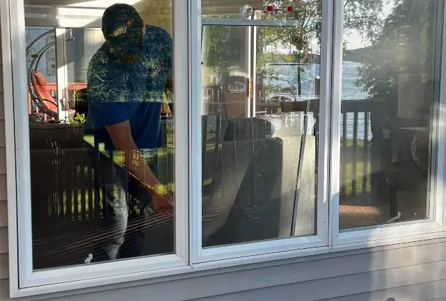 WowFix technician servicing a sliding door from the exterior on a Triangle job