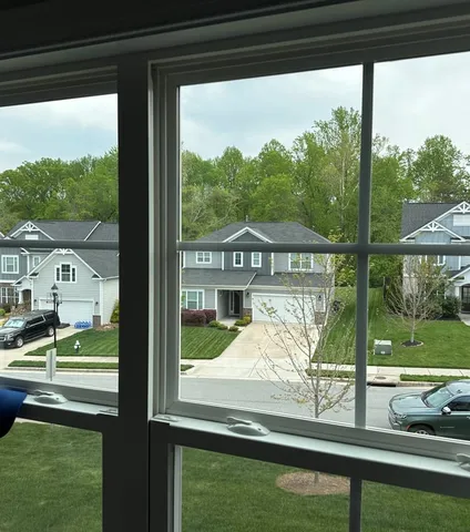 Clear, fog-free double-hung windows with colonial grids after WowFix double-pane glass repair in a Charlotte, NC neighborhood