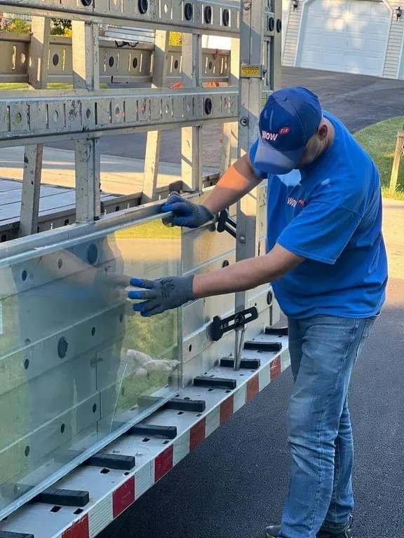 WowFix technician unloading a made-to-measure glass unit from the truck rack