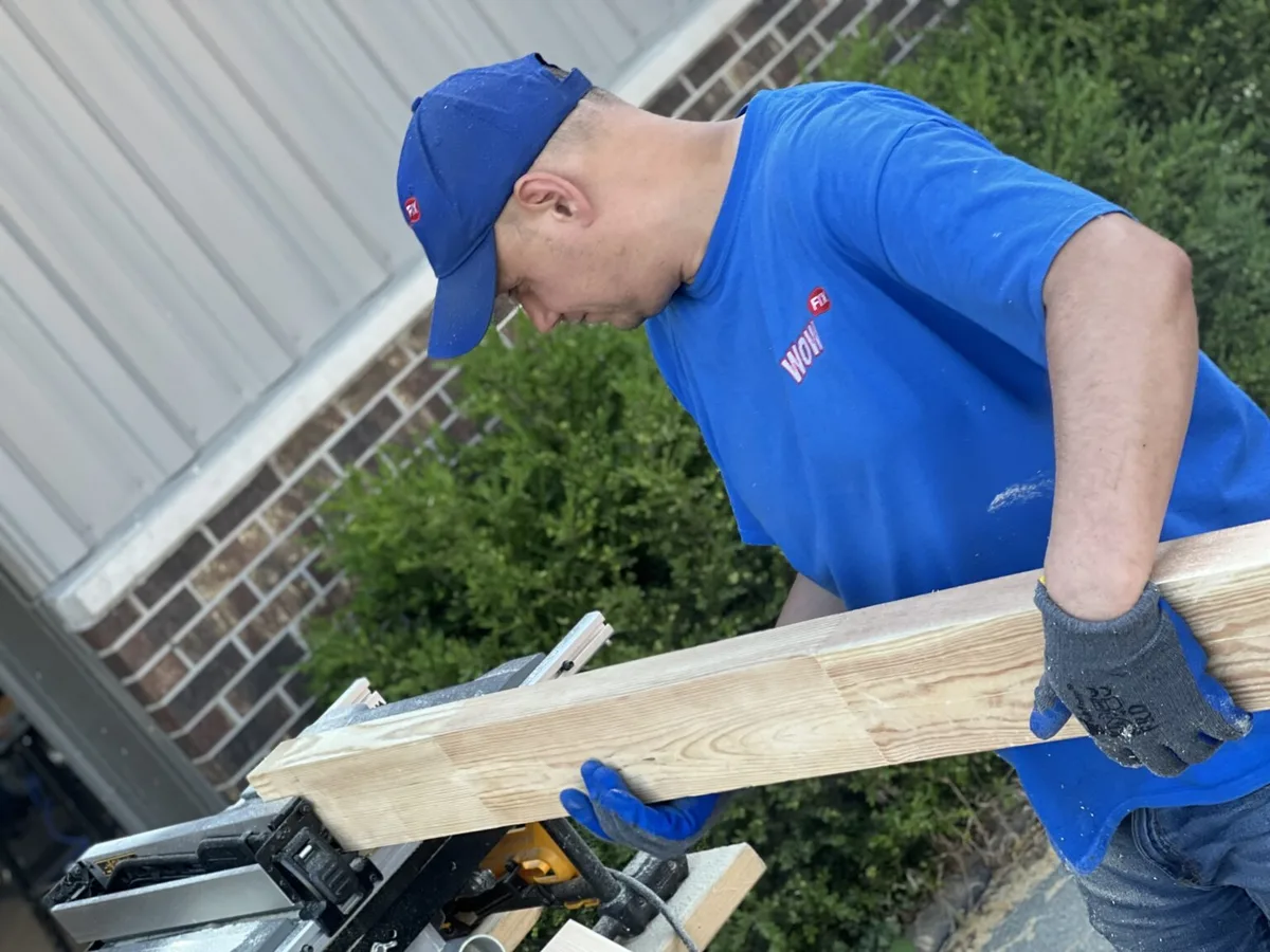 Eugene fitting milled lumber on site — a surgical wood rebuild in progress