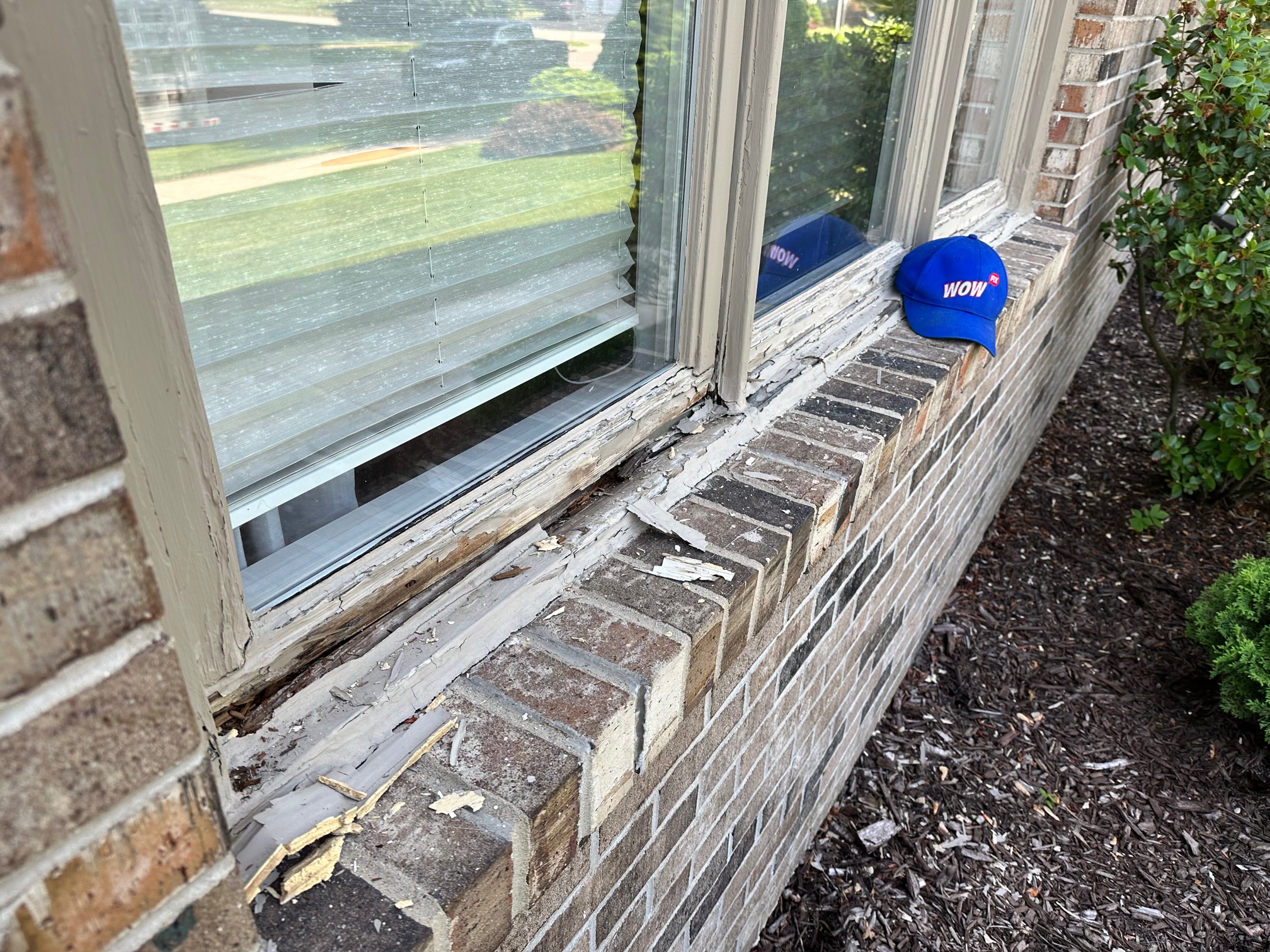 Expert hands working diligently to restore a damaged window sill