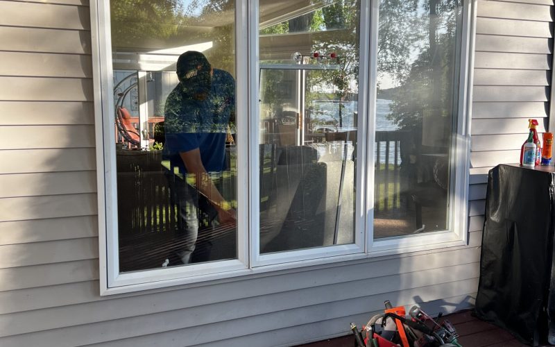 Professional window installation service in progress on residential home in Charlotte, showing tools and triple-pane window setup