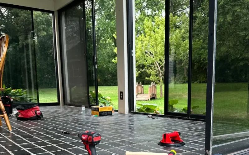 Skilled technicians repairing sliding glass doors for improved performance.
