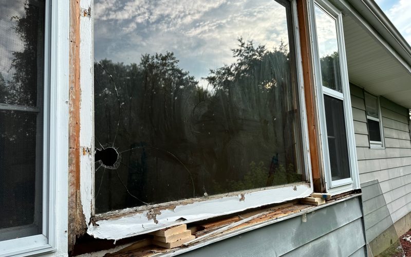 Damaged residential window with broken glass and rotting frame showing severe deterioration, requiring professional window repair in Greensboro