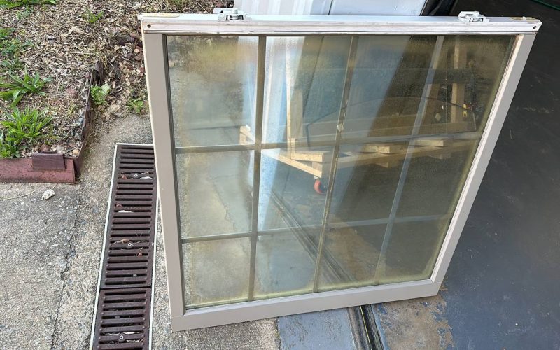 Foggy double-pane window showing seal failure with condensation between glass panes, demonstrating need for window repair
