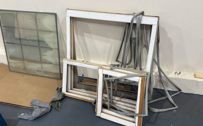 Disassembled window frames and glass units showing window repair and replacement components in North Carolina
