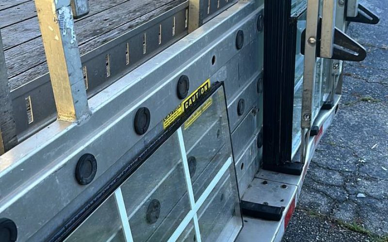 Professional window glass storage rack system with multiple aluminum frames and safety glass panels in organized sections