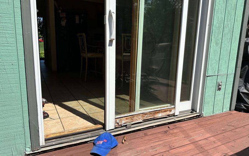 Damaged sliding glass door track showing wood rot and wear, requiring professional door repair services in Huntersville NC